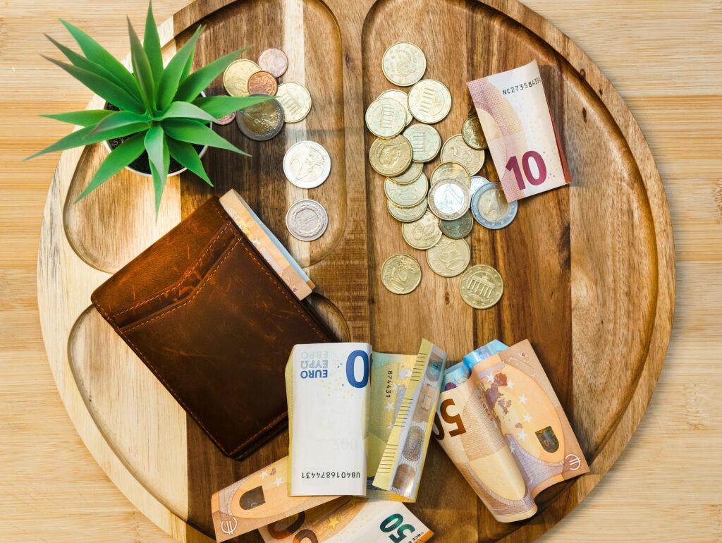 A wooden table topped with lots of money
